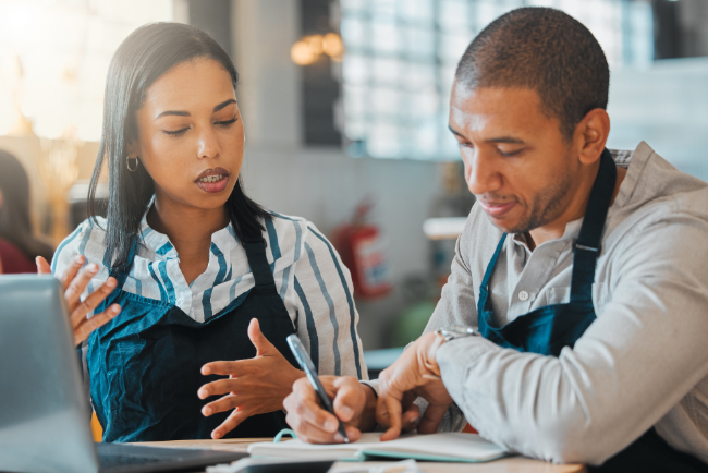 Two Business Owners discussing information. 